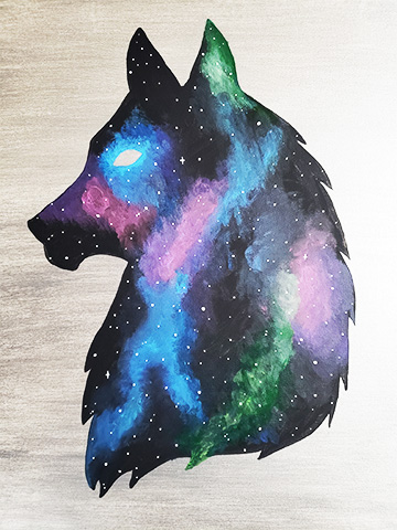 a silhouette of a wolf head with a galaxy painted inside